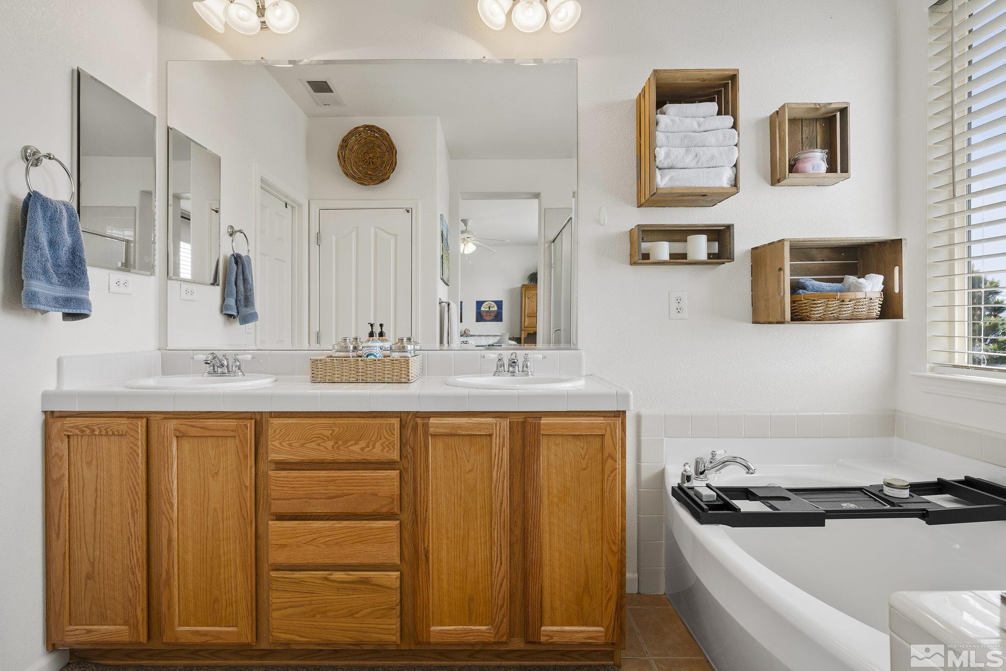 8065 Fire Opal Lane Reno, NV 89506 - Photo 10 of 31 a bathroom with a sink a mirror and a toilet