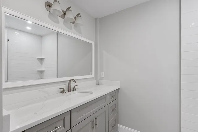 a bathroom with a sink and a mirror