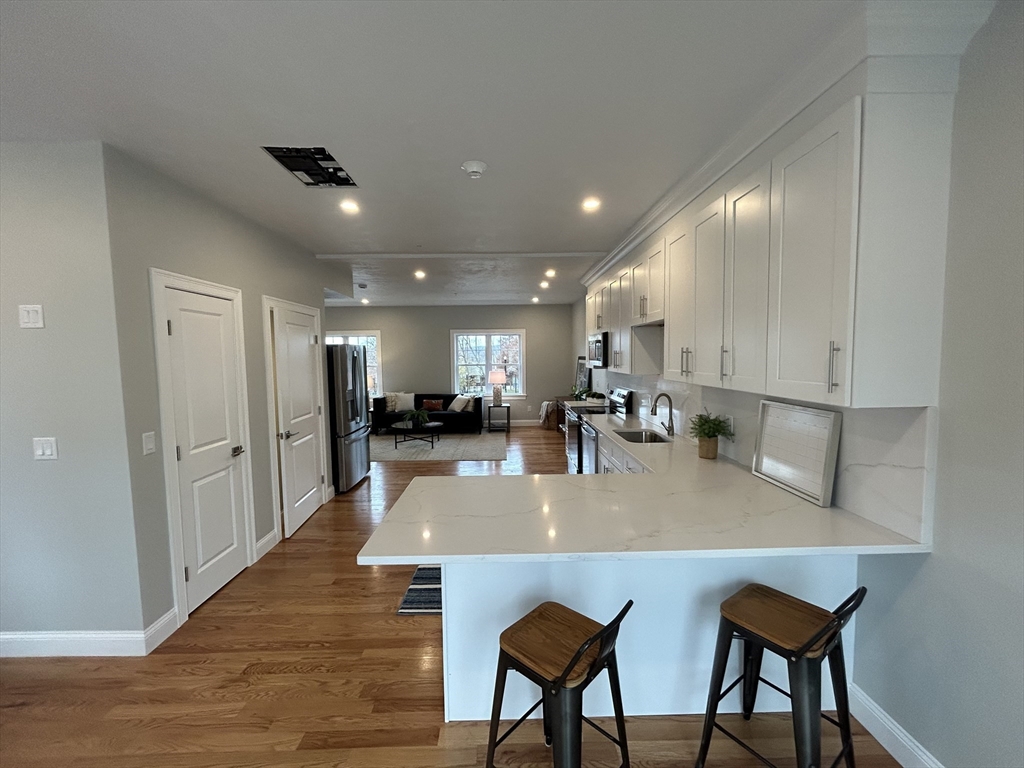 10 Windsor Street, Unit B Worcester, MA 01605 - Photo 5 of 38 a large kitchen with stainless steel appliances lots of counter space and breakfast area