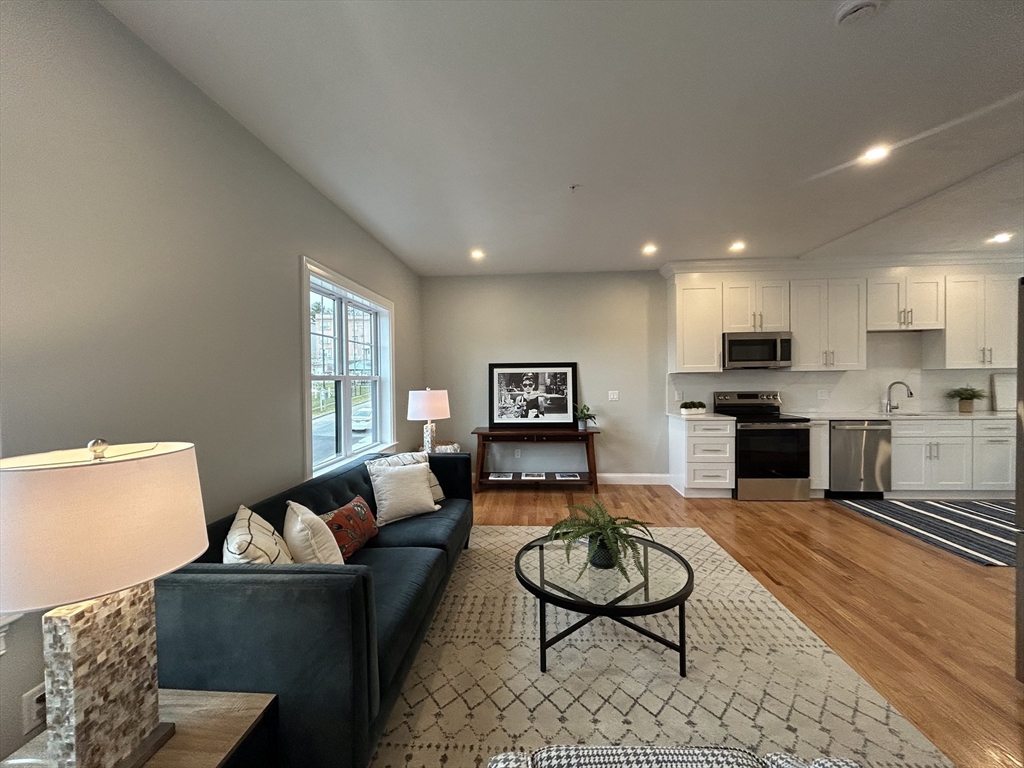 10 Windsor Street, Unit B Worcester, MA 01605 - Photo 8 of 38 a living room with furniture and a wooden floor