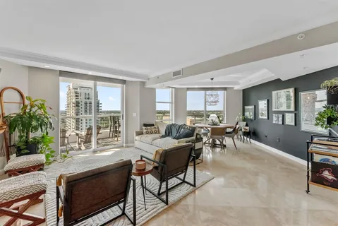 a living room with furniture and a floor to ceiling window
