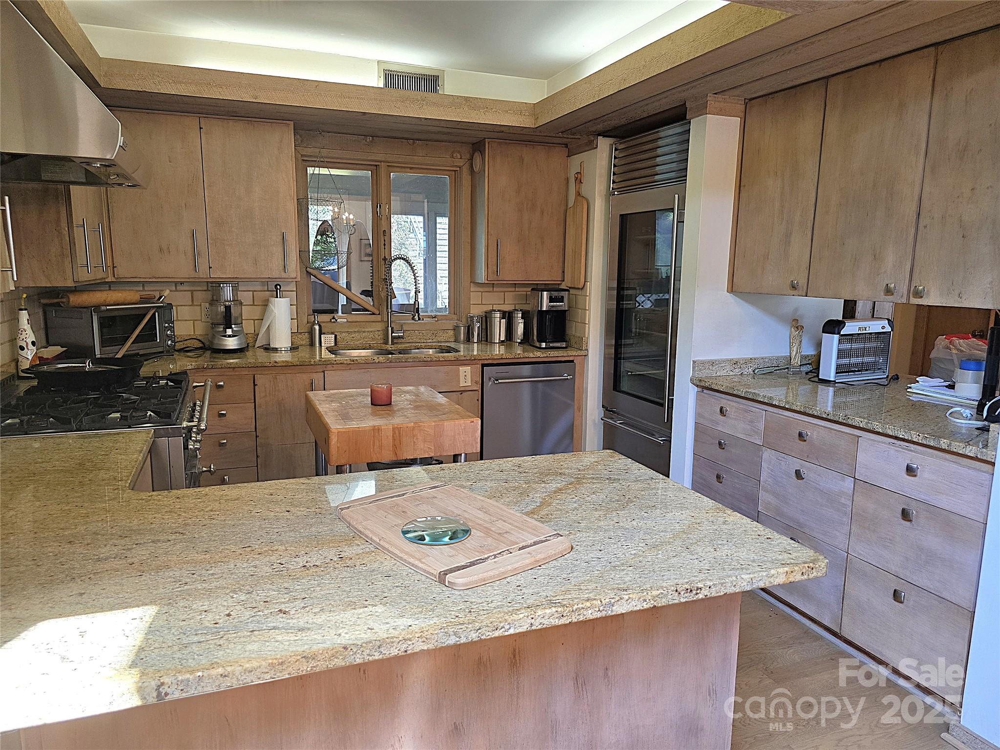 6580 Central Drive Conover, NC 28613 - Photo 11 of 27 a kitchen with stainless steel appliances kitchen island granite countertop a sink dishwasher stove and refrigerator