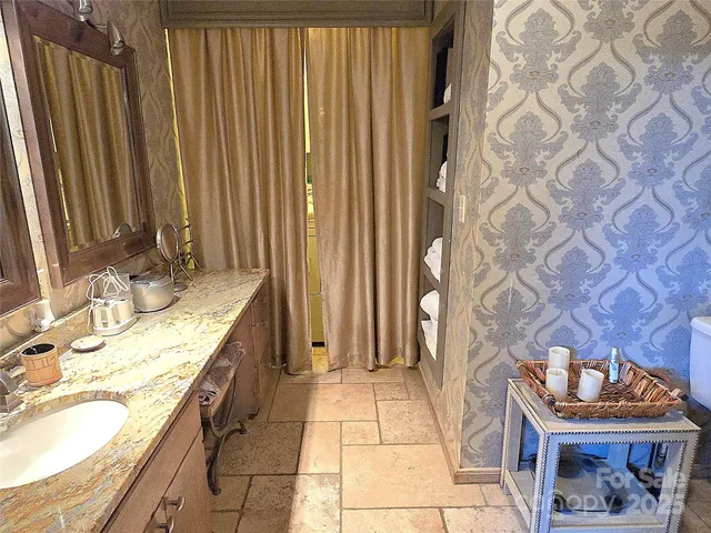 a large bed sitting in a bedroom next to a window