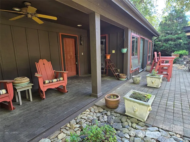 a view of a dinning tables and chairs in backyard of a house