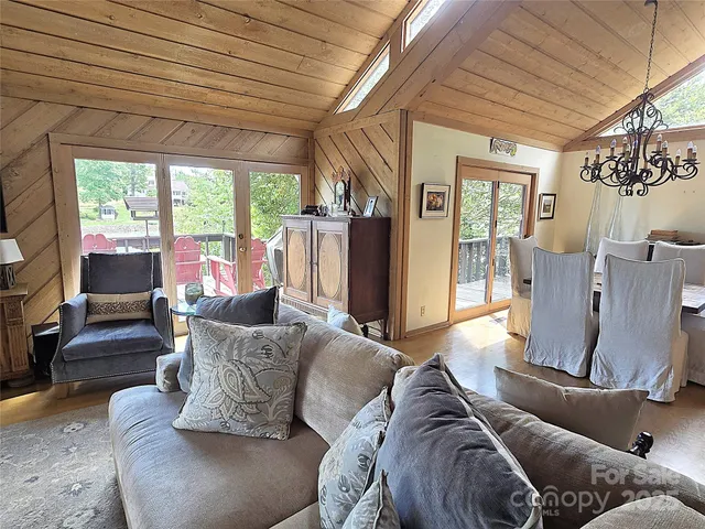 a living room with furniture flat screen tv and a large window