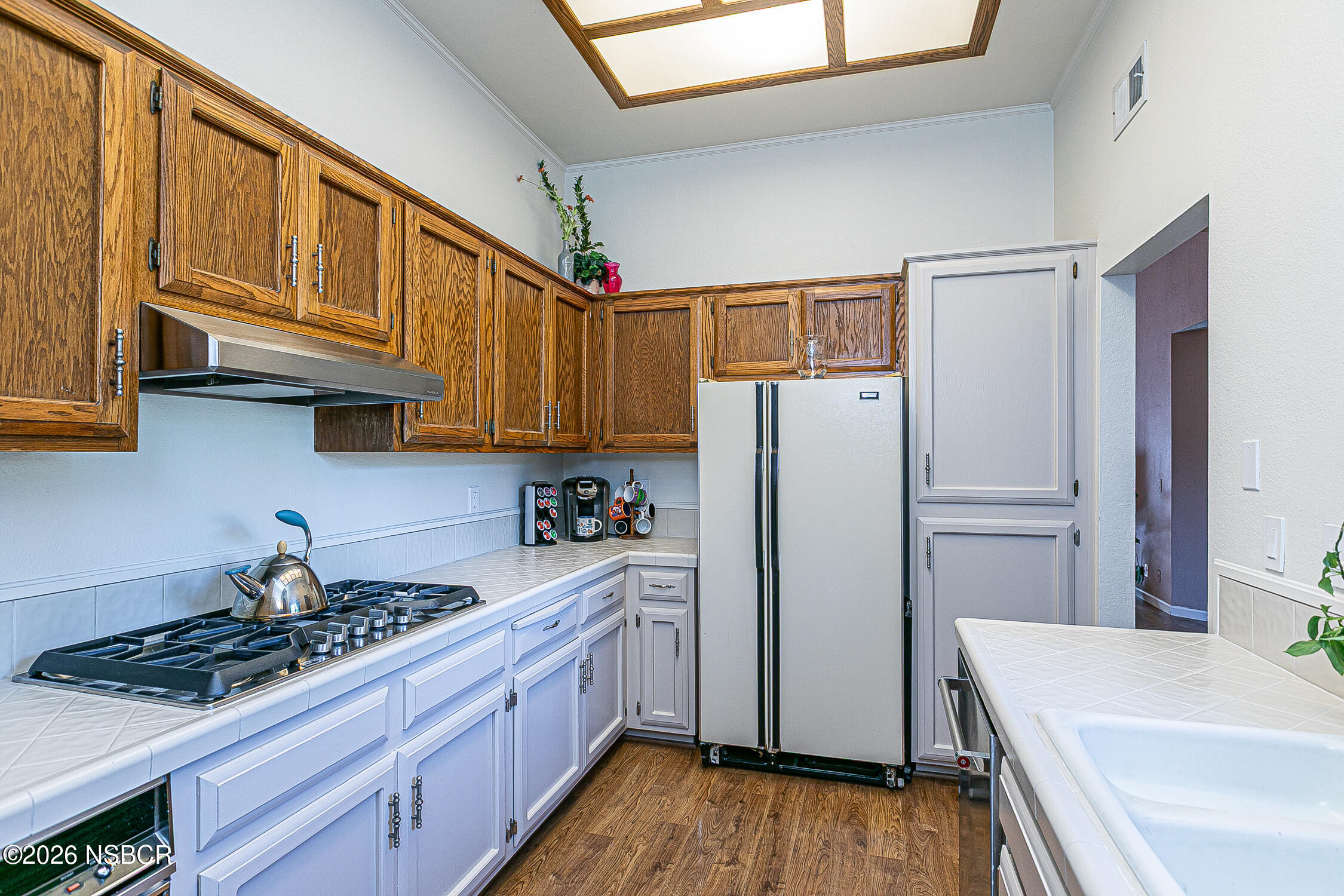 1412 Oakridge Park Road Santa Maria, CA 93455 - Photo 11 of 35 a kitchen with stainless steel appliances a refrigerator a sink and wooden cabinets