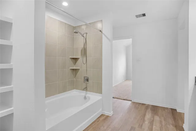 a bathroom with a bathtub and a shower