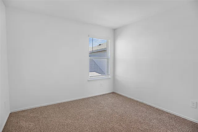 a view of an empty room and a window