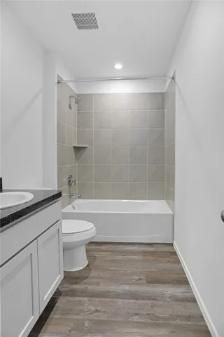a bathroom with a toilet a sink and bathtub
