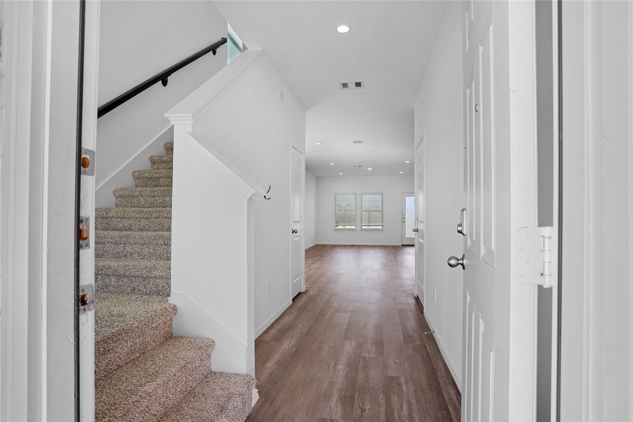 24311 Saddlestone Green Dr Spring Spring, TX 77373 - Photo 3 of 36 a view of a hallway with wooden floor and staircase