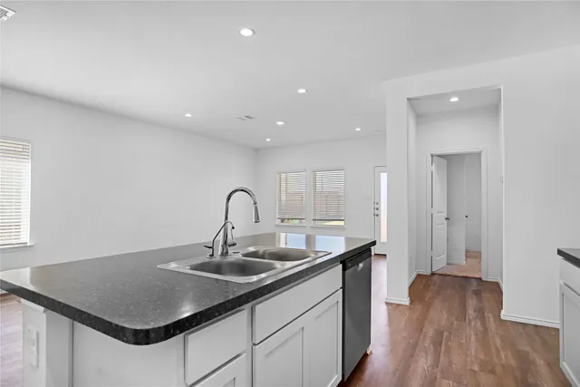a kitchen with a sink and cabinets