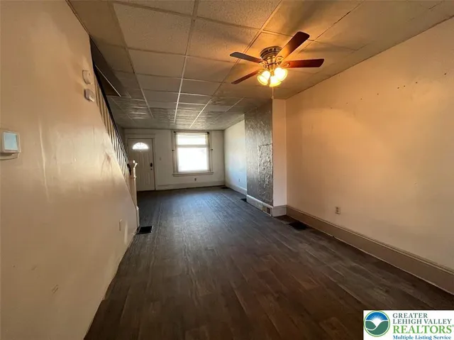 a kitchen with stainless steel appliances granite countertop a refrigerator a sink and white cabinets