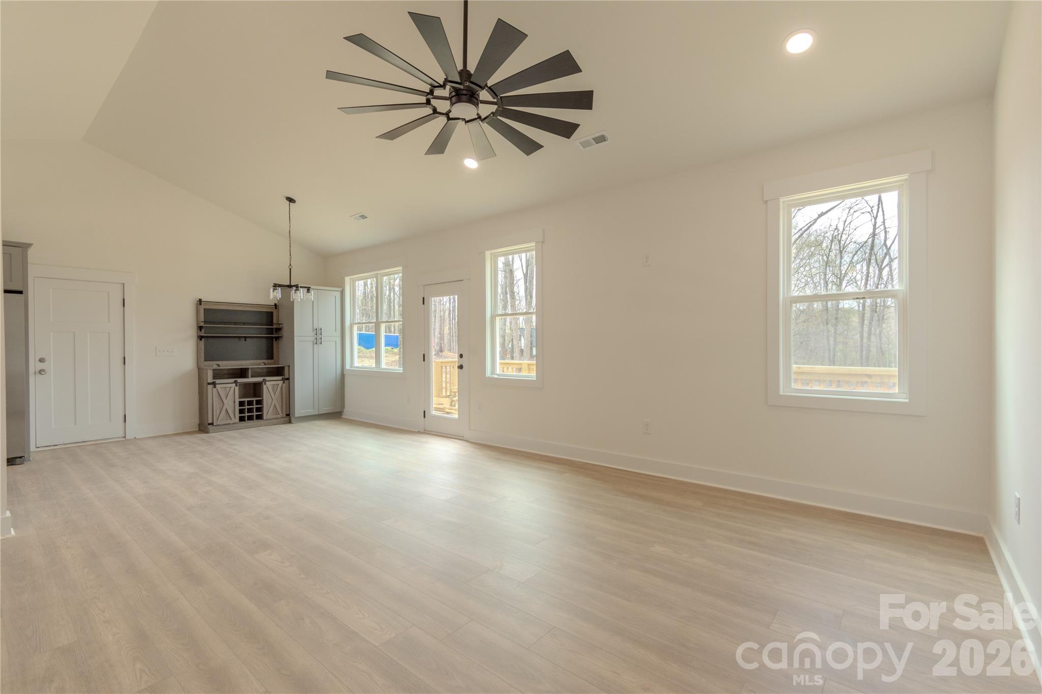 10303 Sycamore Road, Unit 90 Norwood, NC 28128 - Photo 12 of 42 an empty room with windows and cabinet