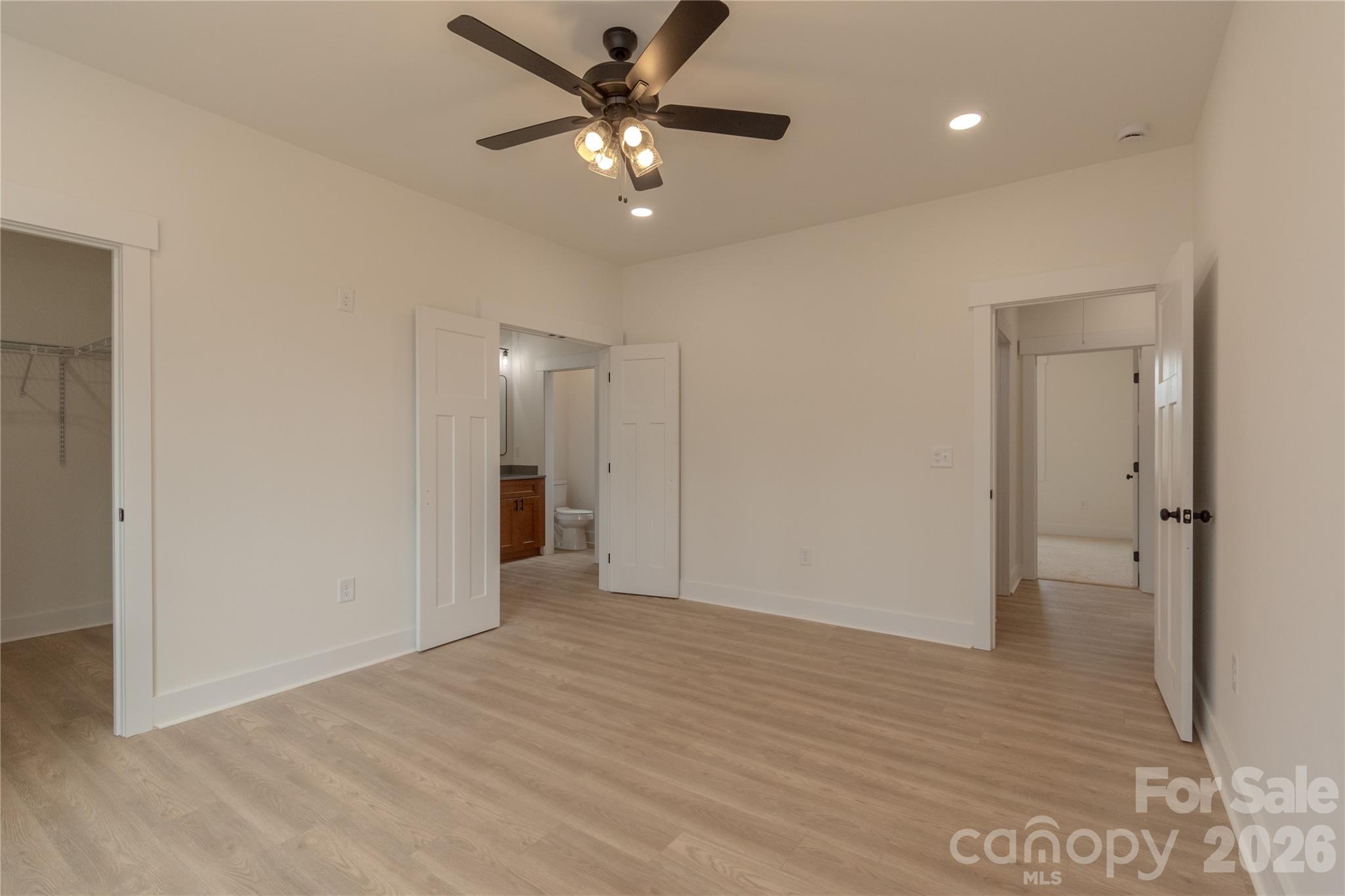 10303 Sycamore Road, Unit 90 Norwood, NC 28128 - Photo 23 of 42 a view of an empty room and chandelier fan