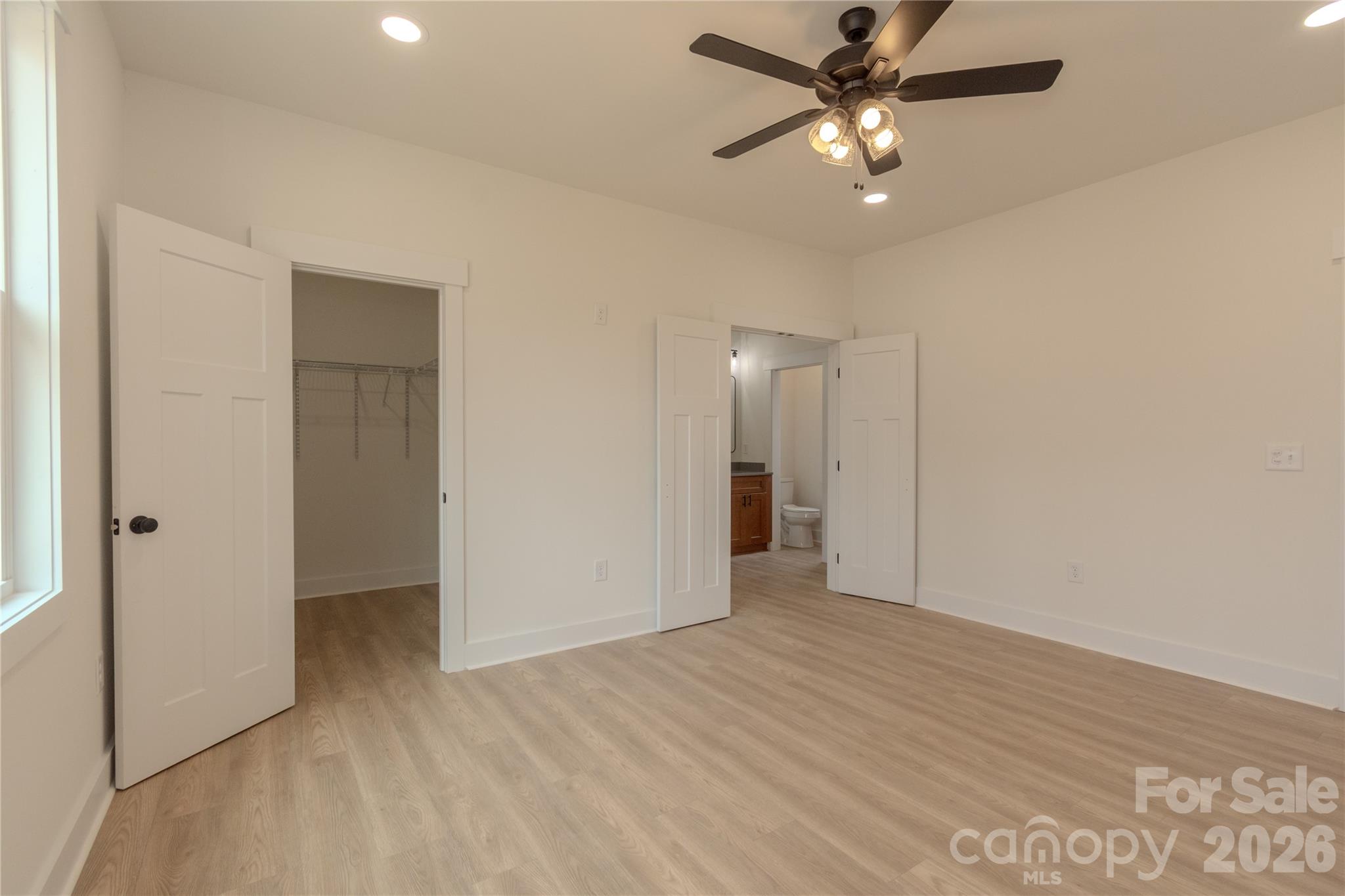 10303 Sycamore Road, Unit 90 Norwood, NC 28128 - Photo 24 of 42 a view of an empty room and a ceiling fan