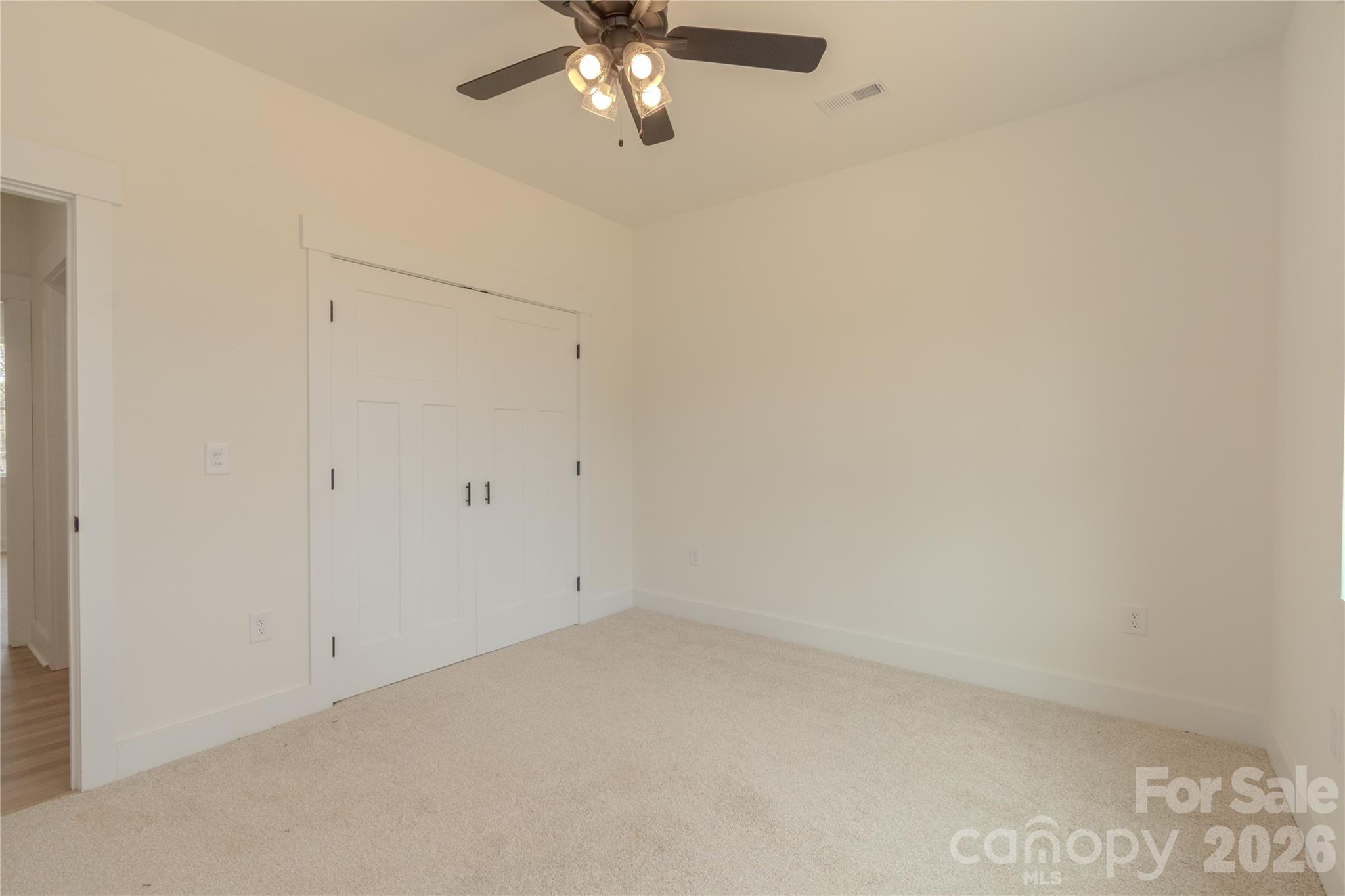 10303 Sycamore Road, Unit 90 Norwood, NC 28128 - Photo 31 of 42 an empty room with a chandelier fan