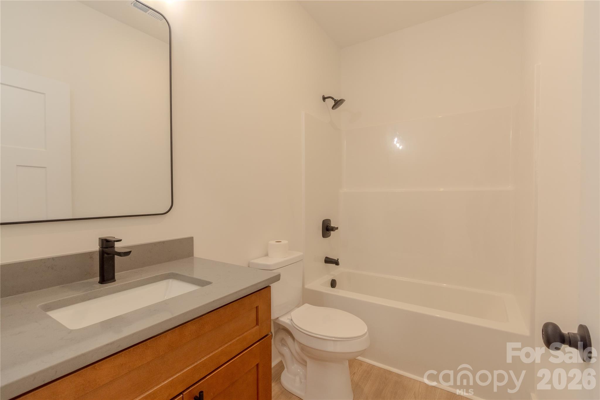 10303 Sycamore Road, Unit 90 Norwood, NC 28128 - Photo 42 of 42 a bathroom with a sink a toilet and shower