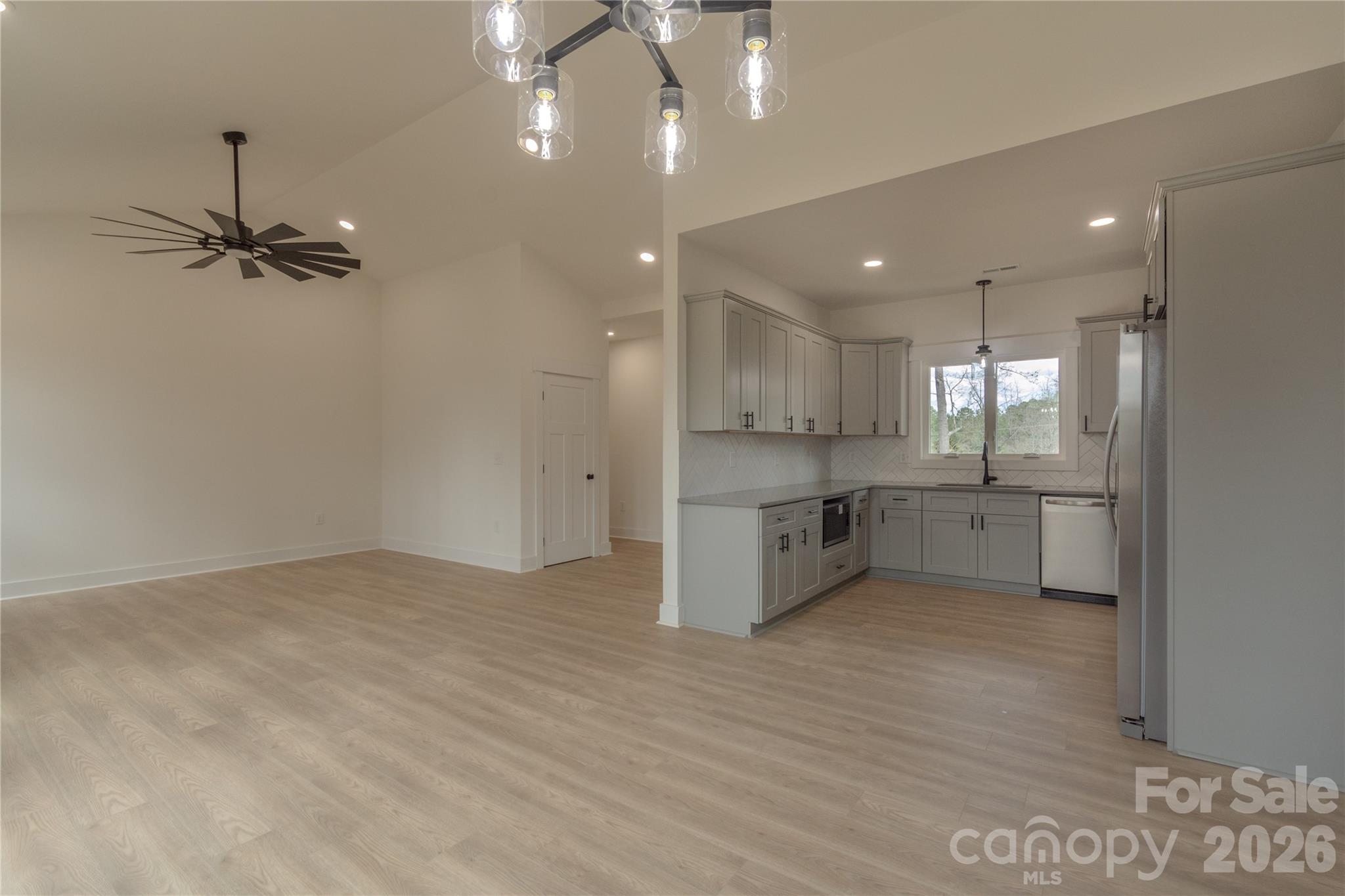 10303 Sycamore Road, Unit 90 Norwood, NC 28128 - Photo 10 of 42 a view of a kitchen with a sink and stainless steel appliances