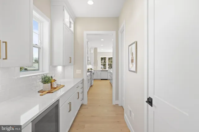 a large kitchen with a large counter top appliances and cabinets