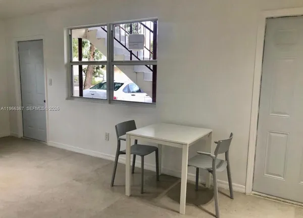 a view of a workspace with furniture