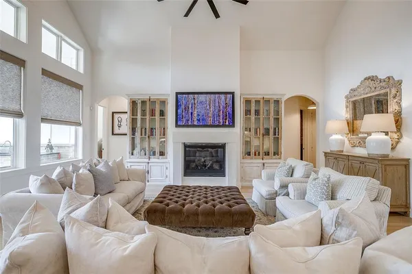 a living room with furniture a fireplace and wall paintings