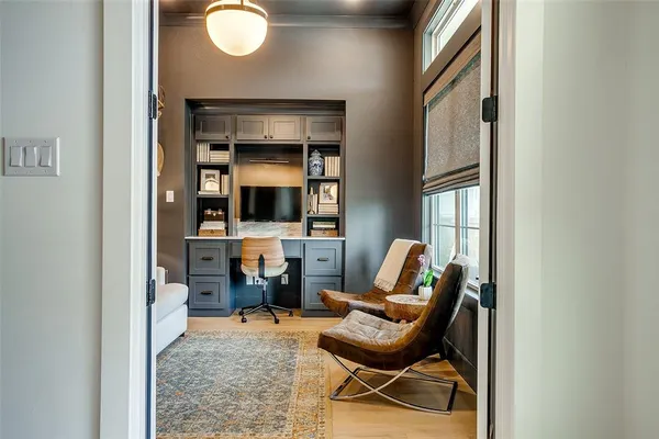 a living room with furniture a flat screen tv and a window
