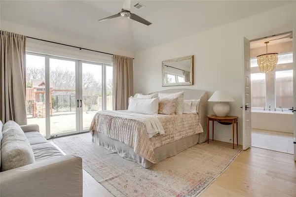 a spacious bedroom with a bed and glass window