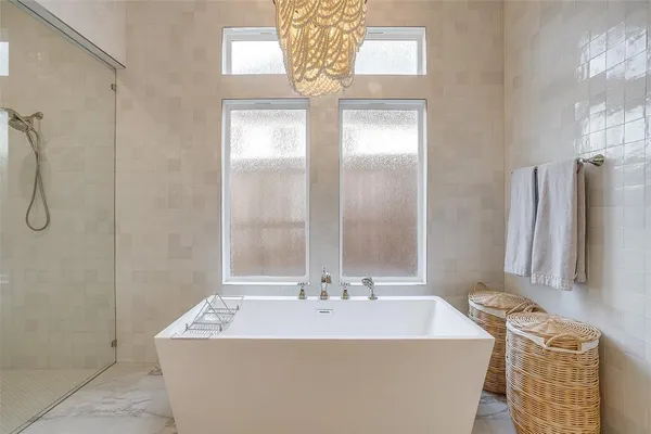 a bath tub sitting next to a bathroom sink