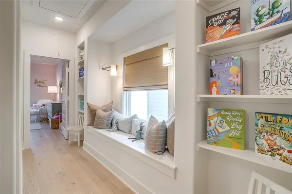 a living room with furniture and painting on the wall