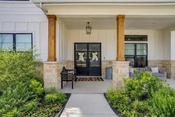 a front view of a house with outdoor seating