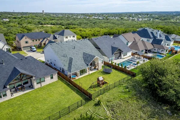 an aerial view of residential houses with outdoor space and city view
