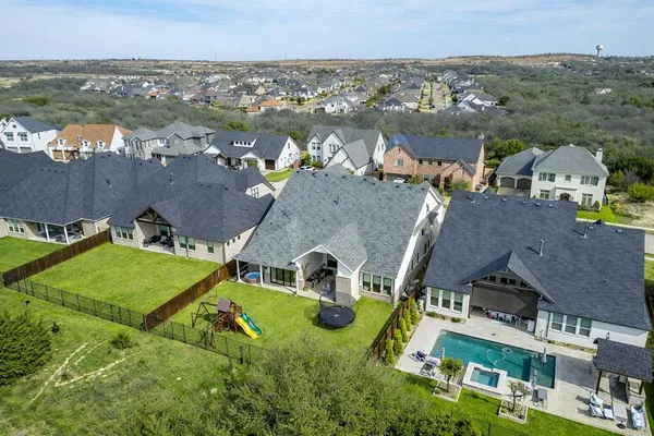 an aerial view of a house with a garden and lake view