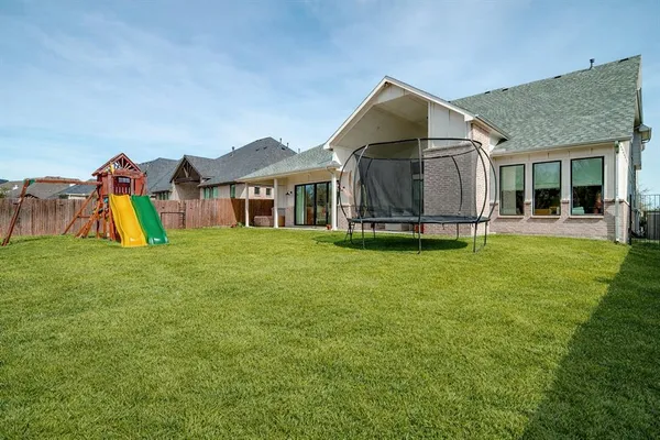 a view of a house with a yard and sitting area