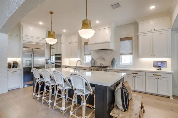 a large kitchen with a table and chairs