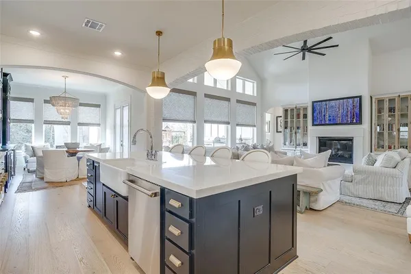 a living room with furniture a fireplace and a chandelier