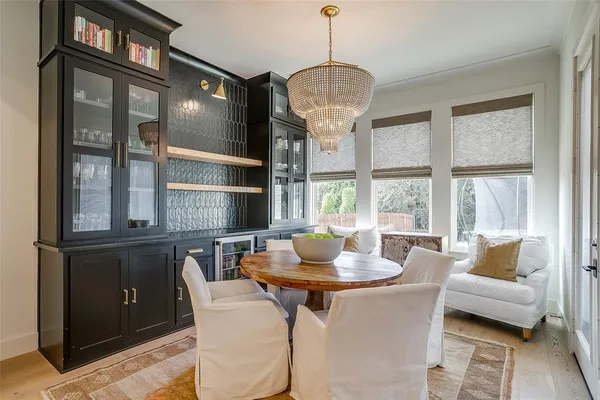 a dining room with furniture a chandelier and wooden floor
