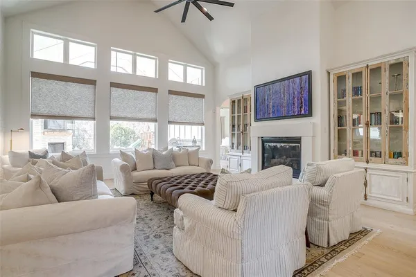 a living room with furniture a large window and a fireplace