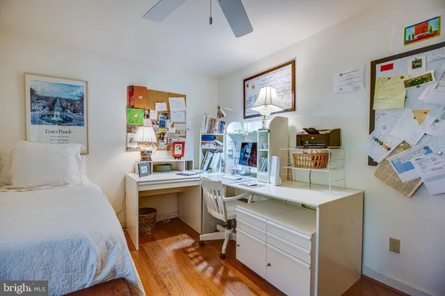 a view of a workspace with furniture and wooden floor