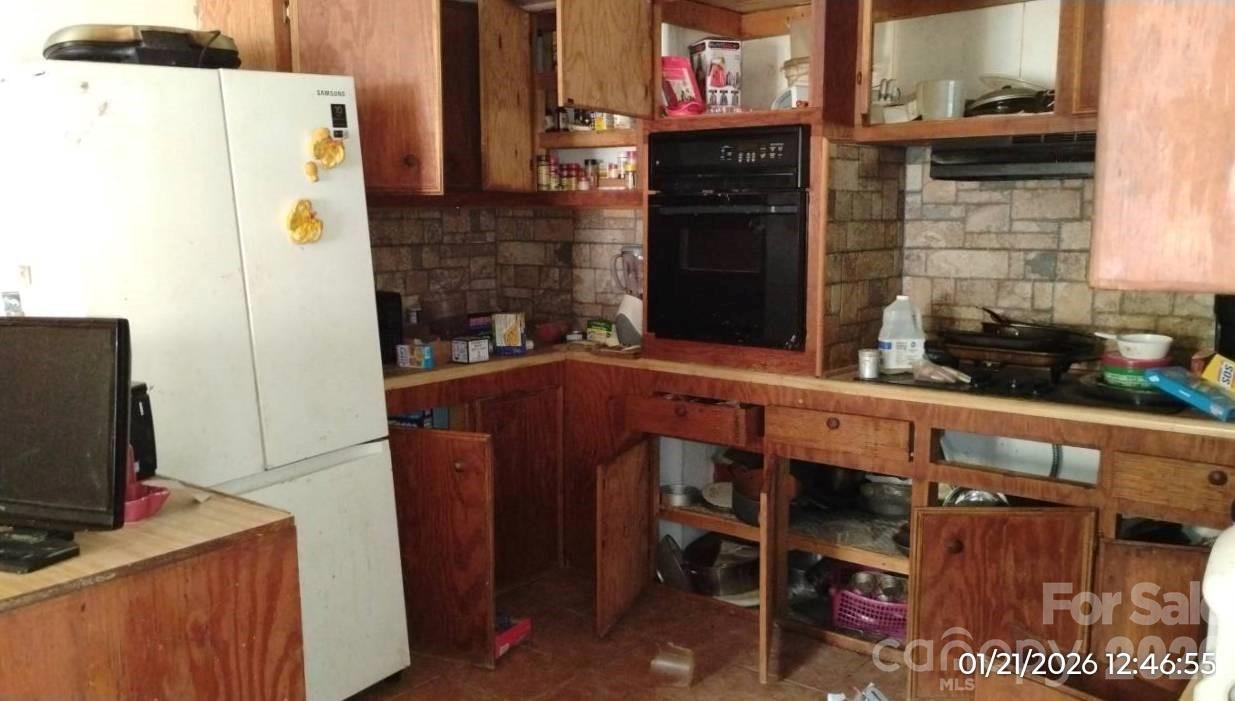337 Red Bank Road Waynesville, NC 28786 - Photo 5 of 9 a kitchen with a refrigerator and a stove top oven