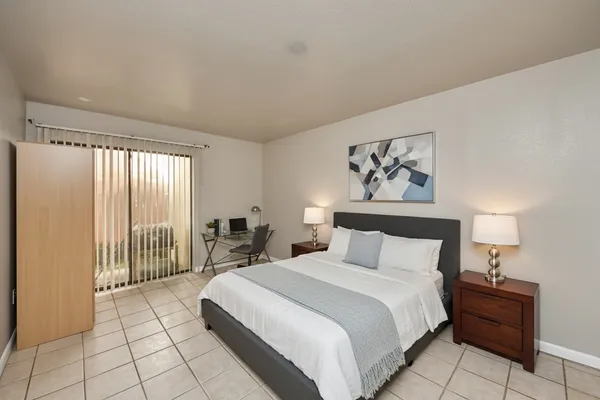 a bedroom with a large bed and a window