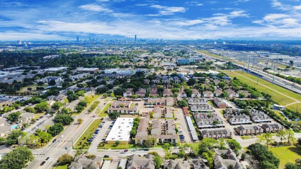 an aerial view of residential houses with outdoor space