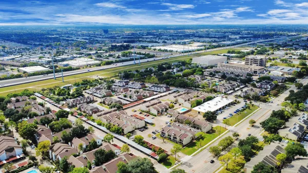 an aerial view of residential building and lake