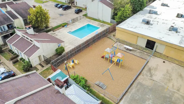 an aerial view of a house with a swimming pool