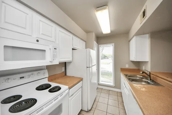 a kitchen with a stove and a sink