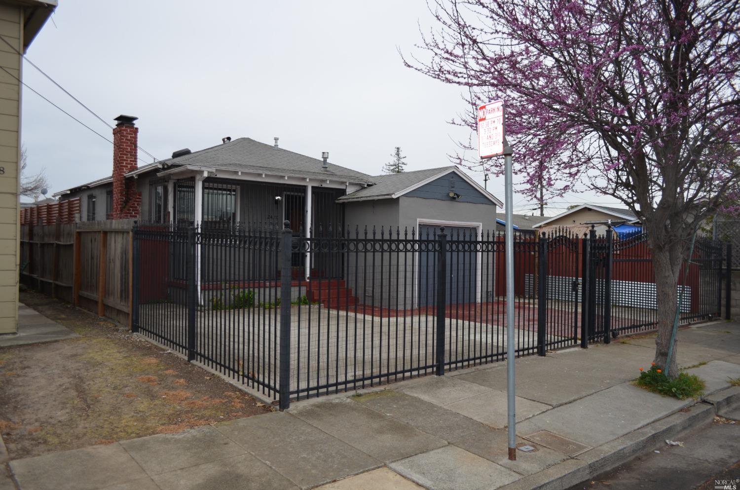 a front view of a house with iron fence