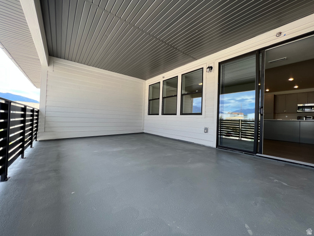 717 West W Coho Lane South, Unit 2F302 Midvale, UT 84047 - Photo 8 of 22 Spacious outdoor patio featuring a gray finished floor and a slatted black railing