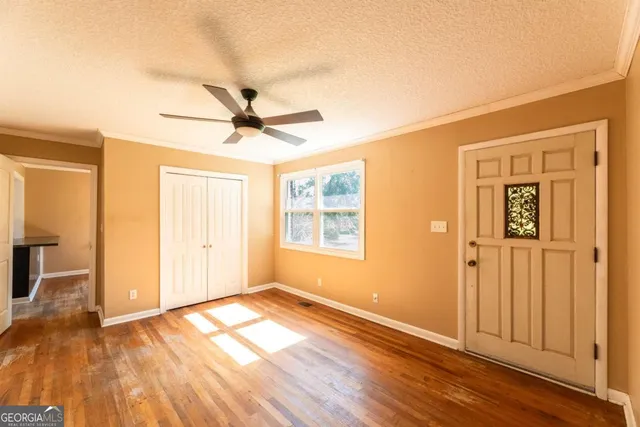 a view of a room with wooden floor and a window