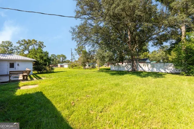 a view of a house with backyard space and windows