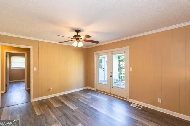 wooden floor in an empty room with a window