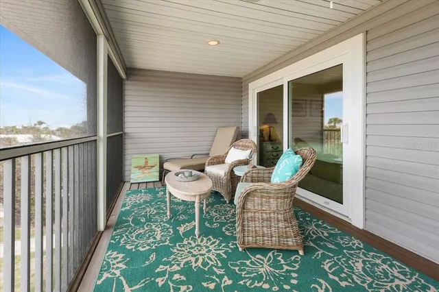 an aerial view of a residential houses with outdoor space and ocean